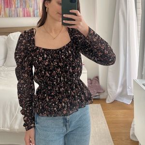 Long sleeve black puff shoulder floral design shirt. Peplum bottom NEW WITH TAGS